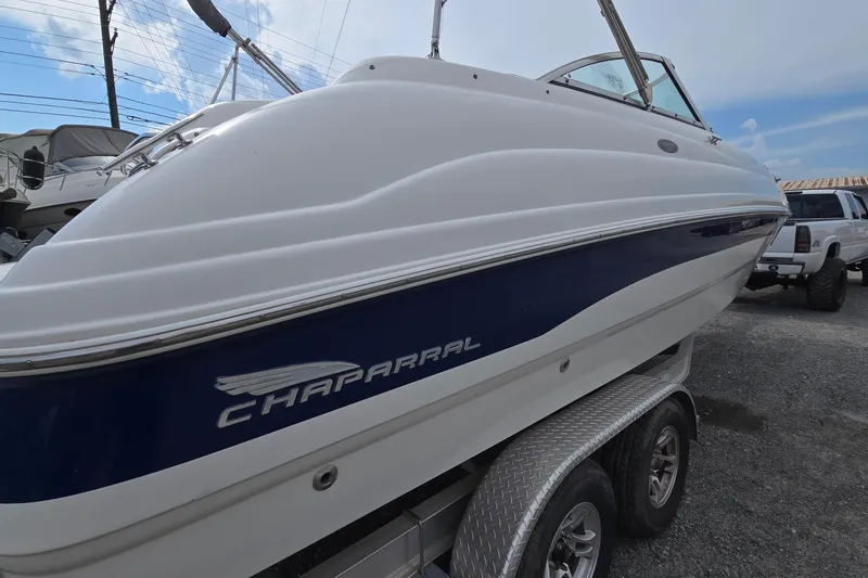 Slide: The Image of 2001 Chaparral Sunesta 233 boat on trailer, side view with blue and white design. - 5