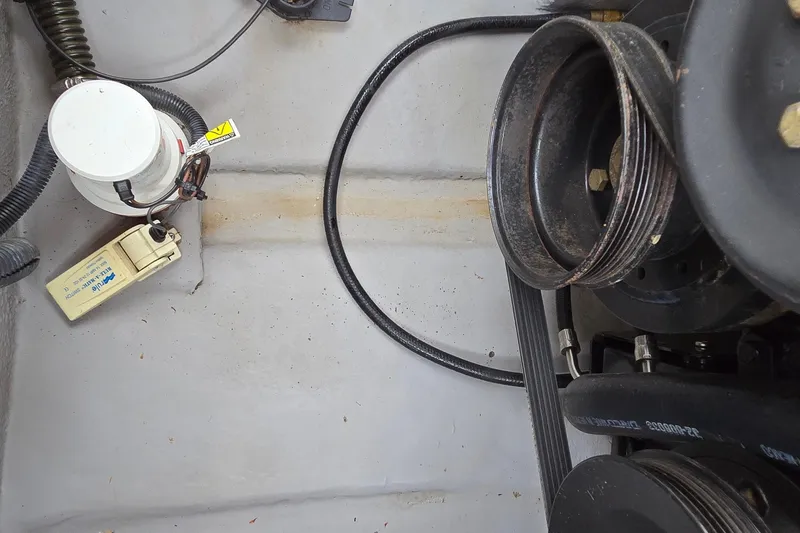 Slide: The Image of Engine compartment of a 2001 Chaparral Sunesta 233 boat, showing belts and components. - 50