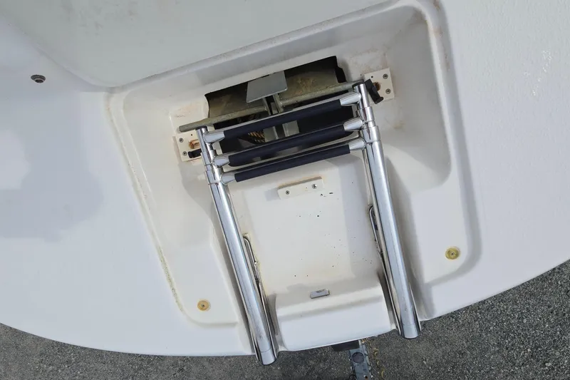 Slide: The Image of 2001 Chaparral Sunesta 233 boat ladder, stainless steel, folded on deck. - 52
