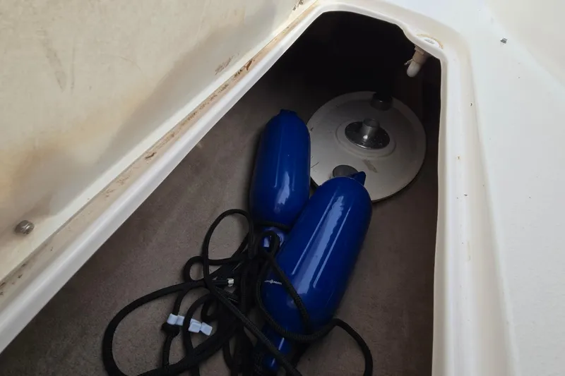 Slide: The Image of Storage compartment in 2001 Chaparral Sunesta 233 with blue fenders and anchor. - 53