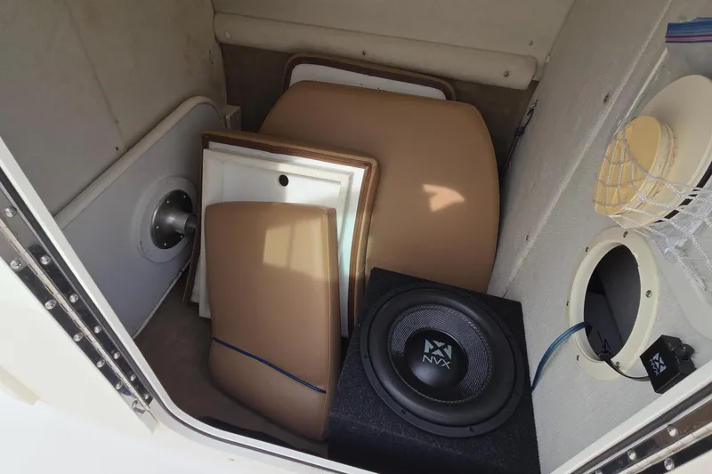 Slide: The Image of Storage compartment in a 2001 Chaparral Sunesta 233 boat with speaker and cushions. - 56