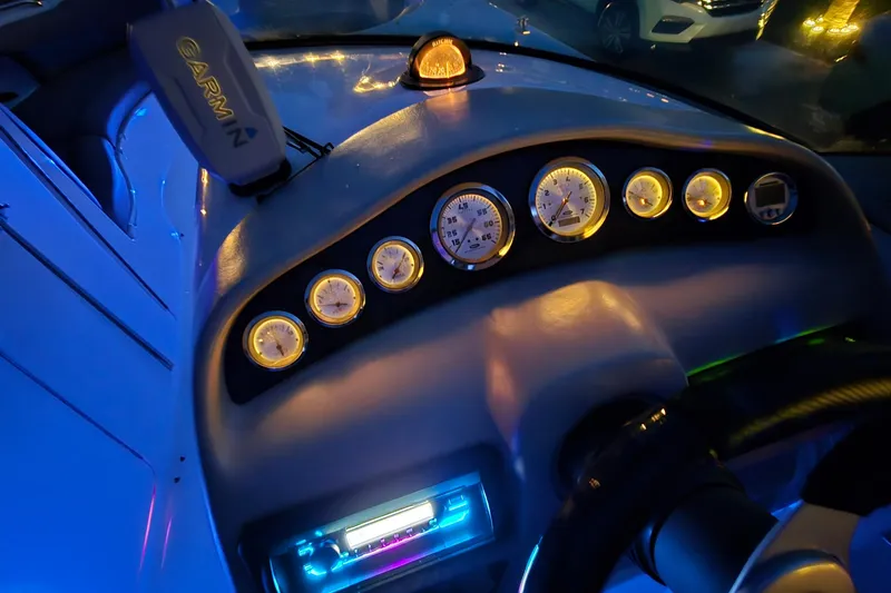 Slide: The Image of 2001 Chaparral Sunesta 233 dashboard with illuminated gauges and Garmin device. - 61