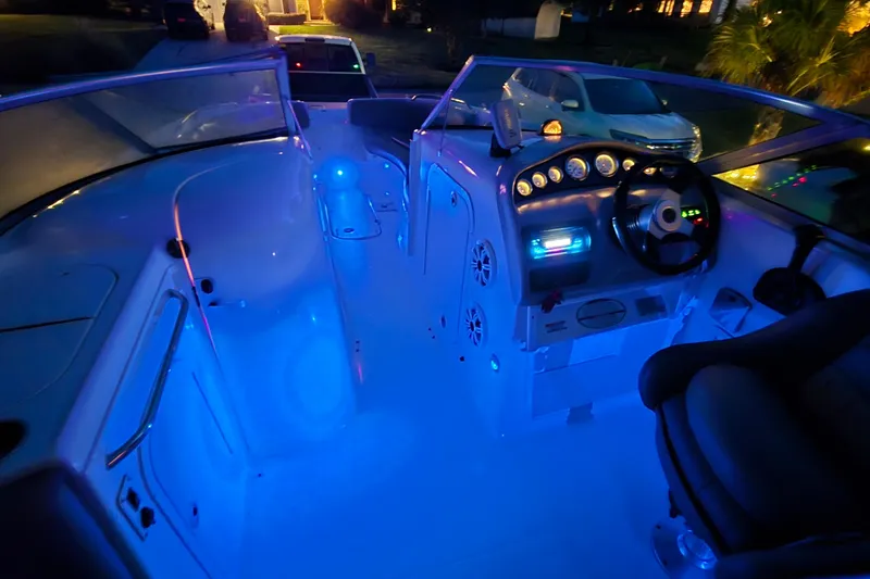 Slide: The Image of 2001 Chaparral Sunesta 233 boat interior with blue LED lighting at night. - 62