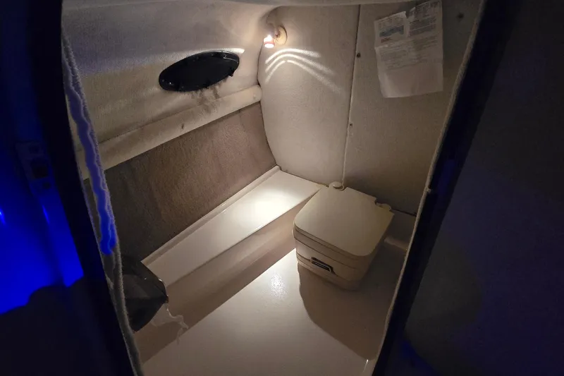 Slide: The Image of 2001 Chaparral Sunesta 233 boat interior with compact toilet and ambient lighting. - 63