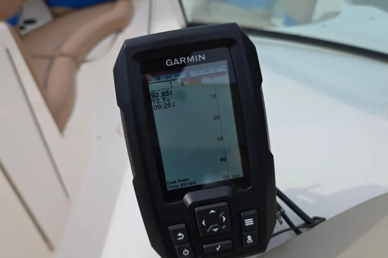 Slide: The Image of Garmin device on 2001 Chaparral Sunesta 233 boat dashboard, displaying depth and voltage. - 66