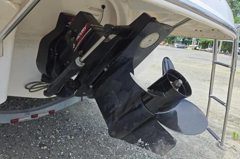 Slide: The Image of 2001 Chaparral Sunesta 233 boat with MerCruiser outdrive and propeller, parked on gravel. - 69