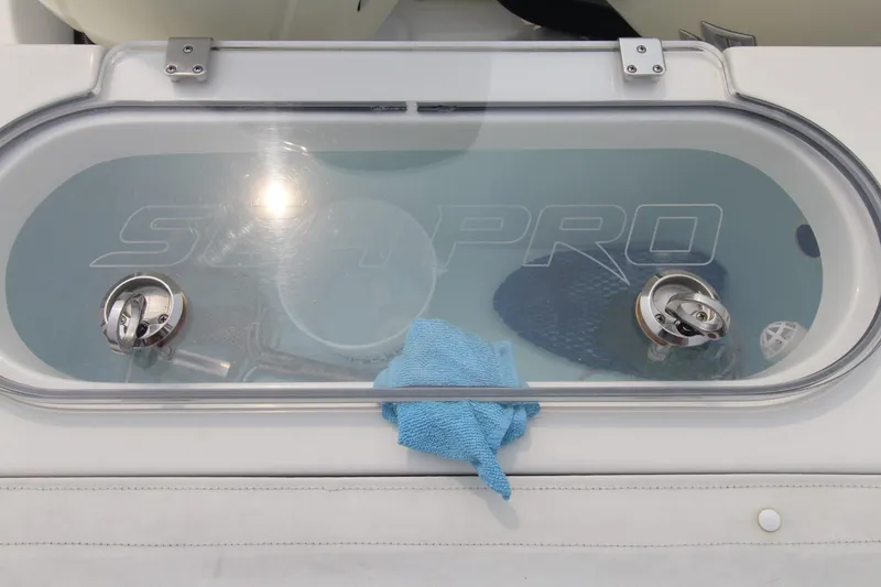 Slide: The Image of 2020 Sea Pro 259 Center Console livewell with blue cloth and clear lid. - 10