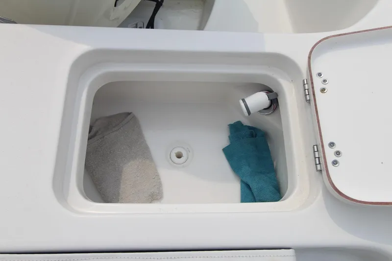 Slide: The Image of Storage compartment on 2020 Sea Pro 259 Center Console boat with towels inside. - 11