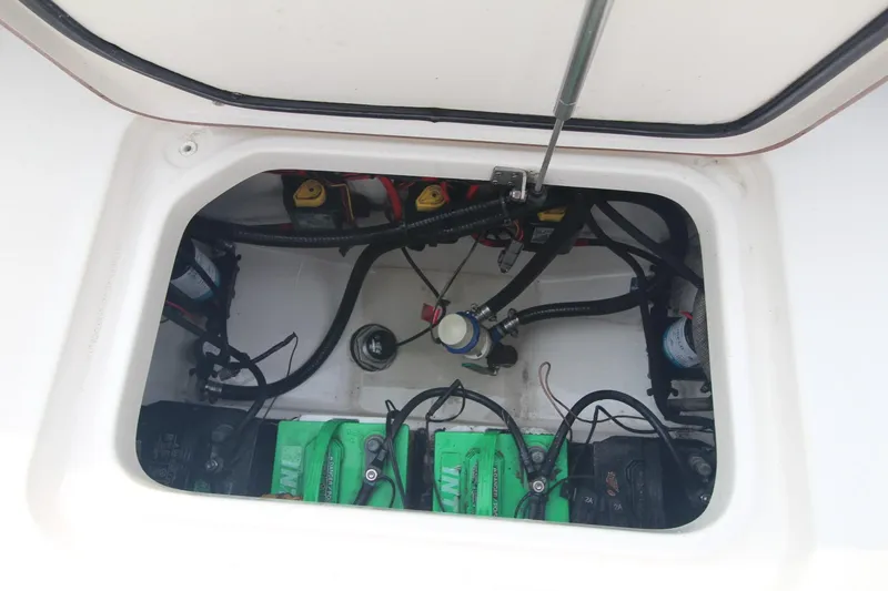 Slide: The Image of 2020 Sea Pro 259 Center Console battery compartment with wiring and components. - 14
