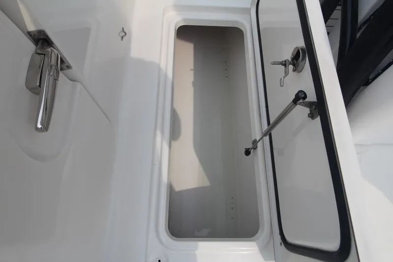 Slide: The Image of Open storage compartment on a 2020 Sea Pro 259 Center Console boat. - 16