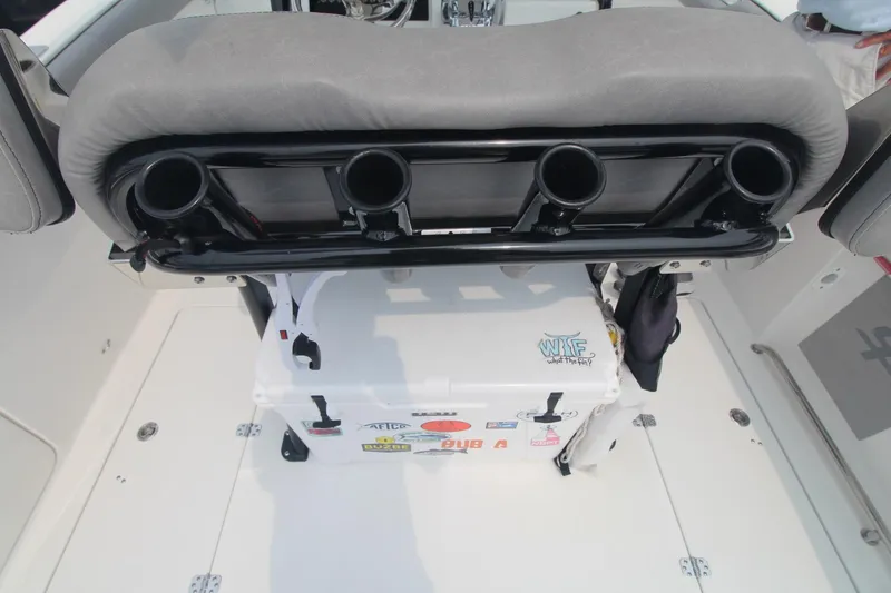 Slide: The Image of 2020 Sea Pro 259 Center Console boat interior with rod holders and cooler. - 17