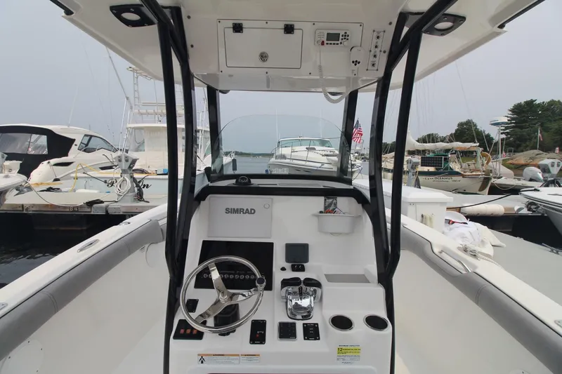 Slide: The Image of 2020 Sea Pro 259 Center Console boat interior with steering wheel and control panel. - 19