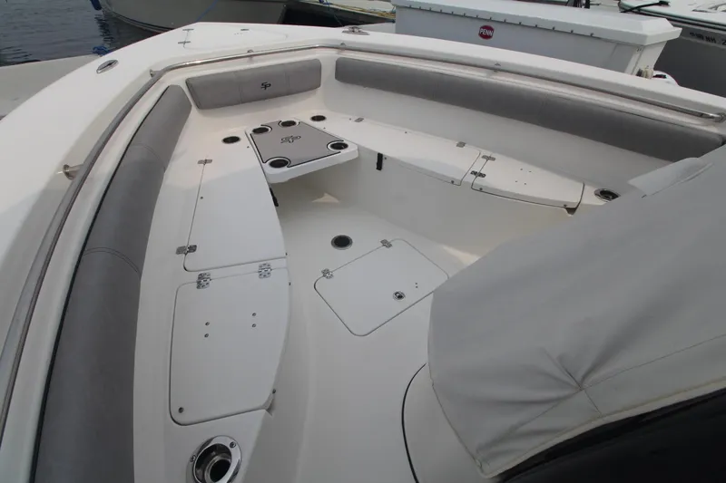 Slide: The Image of 2020 Sea Pro 259 Center Console boat interior with cushioned seating and storage compartments. - 23