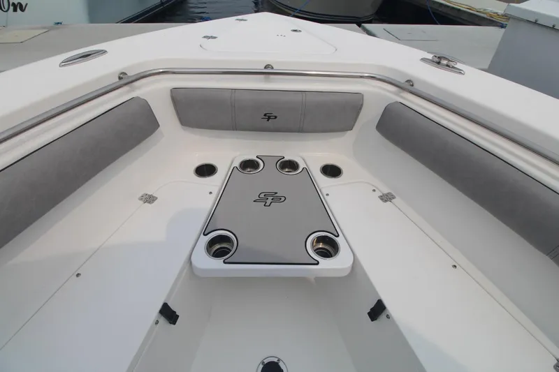 Slide: The Image of 2020 Sea Pro 259 Center Console boat interior with cushioned seating and cup holders. - 24