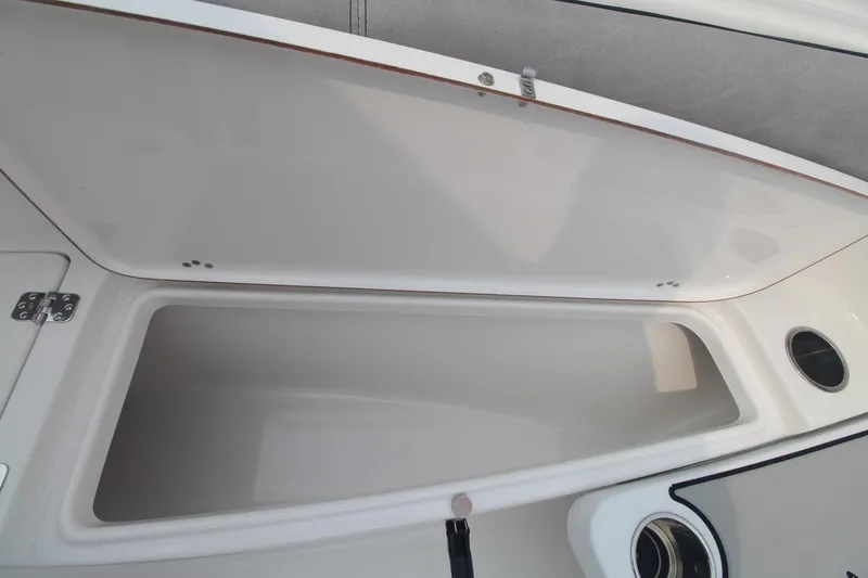 Slide: The Image of 2020 Sea Pro 259 Center Console storage compartment, open lid view. - 27