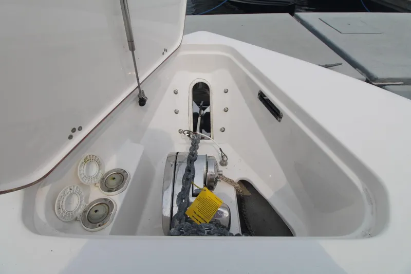 Slide: The Image of Anchor compartment of 2020 Sea Pro 259 Center Console boat, featuring chain and winch. - 28