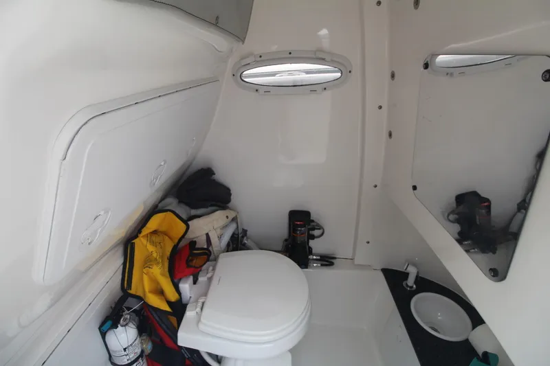 Slide: The Image of 2020 Sea Pro 259 Center Console boat interior with toilet and storage area. - 32