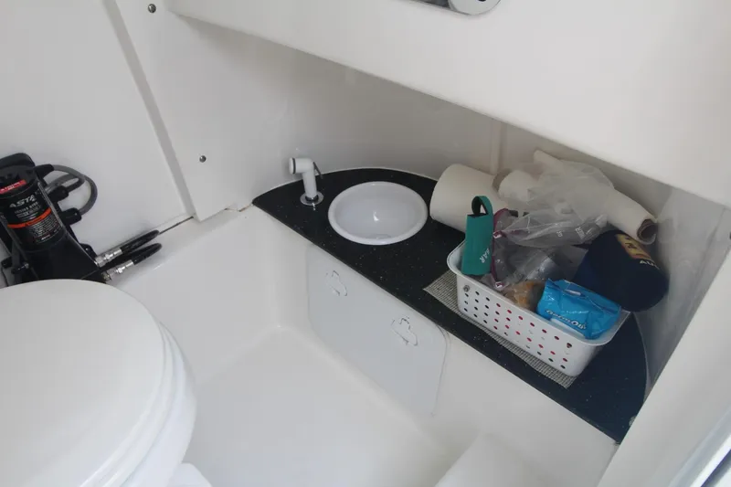 Slide: The Image of 2020 Sea Pro 259 Center Console boat bathroom with sink and storage basket. - 34