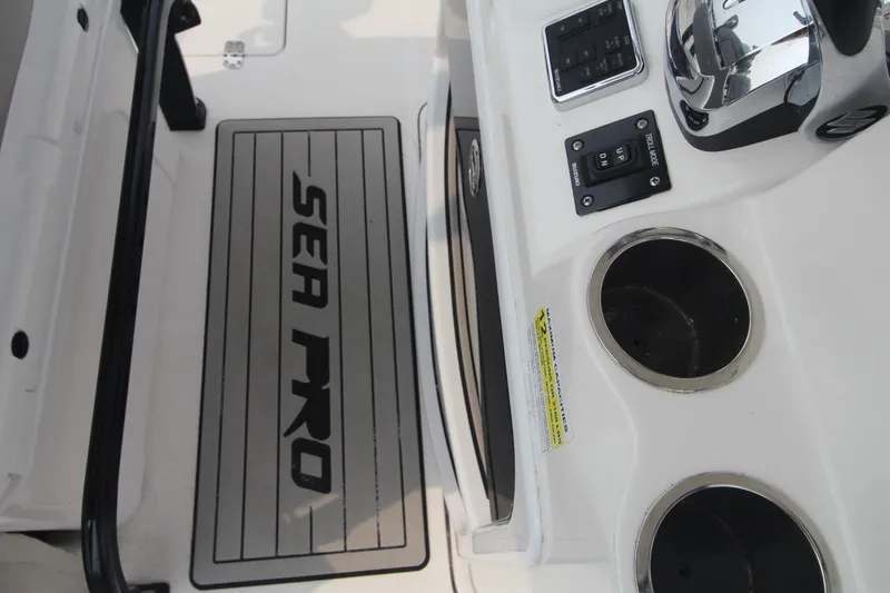 Slide: The Image of 2020 Sea Pro 259 Center Console boat interior with controls and cup holders. - 35