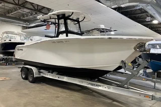 Slide: The Image of 2020 Sea Pro 259 Center Console boat on trailer in indoor showroom. - 41