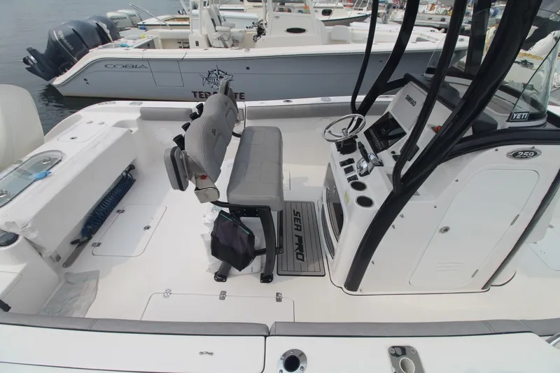 Slide: The Image of 2020 Sea Pro 259 Center Console boat interior with seating and control panel. - 7