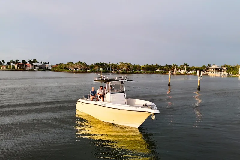 The Image of 2004 Century 2900 Center Console boat on calm water, featuring multiple passengers. - 0