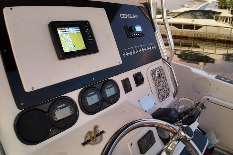 Slide: The Image of Center console of a 2004 Century 2900 boat with navigation equipment. - 12