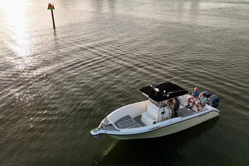 Slide: The Image of 2004 Century 2900 Center Console boat on calm water at sunset with passengers. - 6