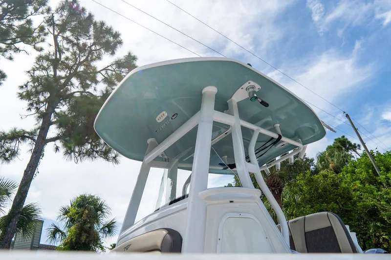 Slide: The Image of 2020 Tidewater 272 CC Adventure boat with T-top against a blue sky. - 10