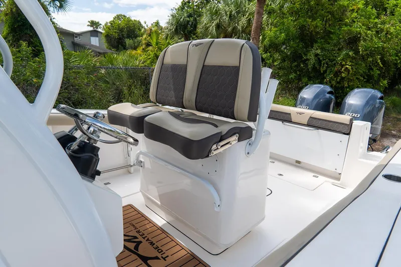 Slide: The Image of 2020 Tidewater 272 CC Adventure boat interior with dual seats and steering wheel. - 11