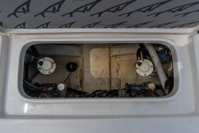 Slide: The Image of 2020 Tidewater 272 CC Adventure boat engine compartment with visible components and wiring. - 18