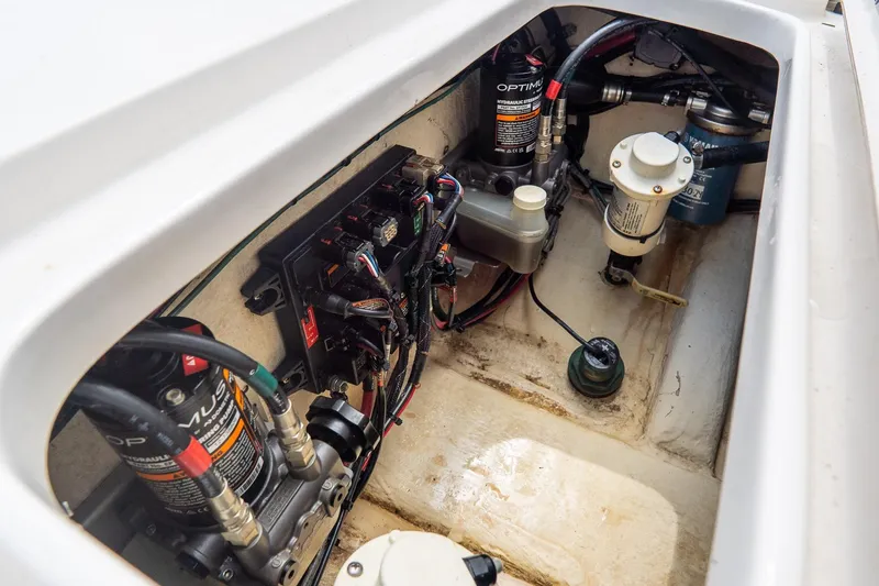 Slide: The Image of 2020 Tidewater 272 CC Adventure boat engine compartment with hydraulic systems and wiring. - 19
