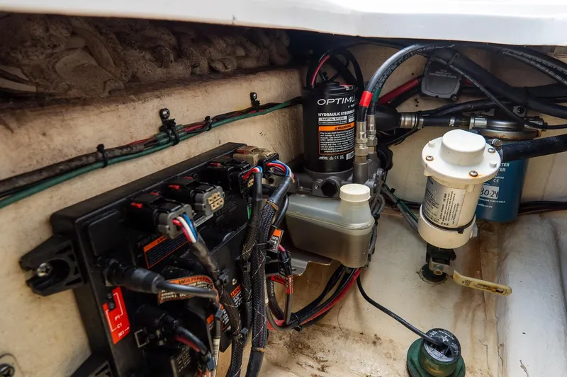 Slide: The Image of 2020 Tidewater 272 CC Adventure boat engine compartment with hydraulic steering and wiring. - 20