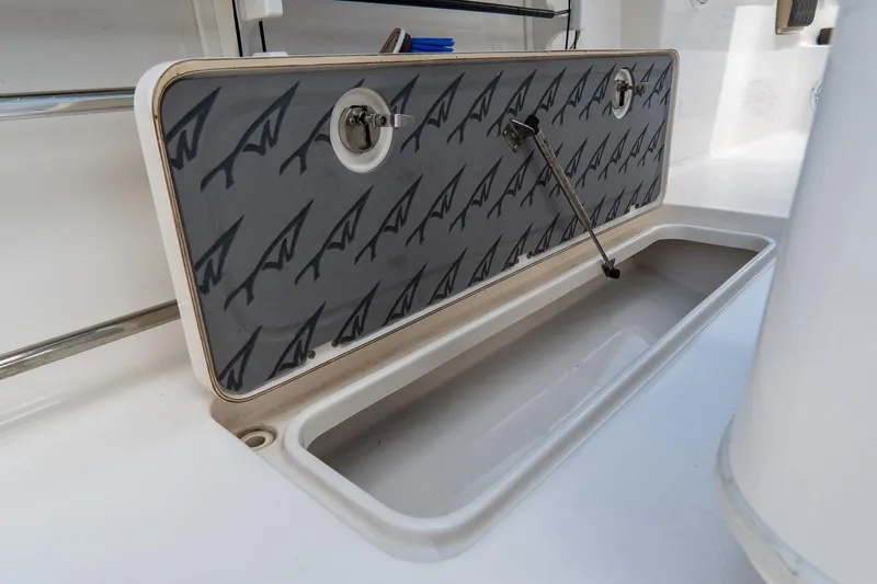 Slide: The Image of Open storage compartment on 2020 Tidewater 272 CC Adventure boat. - 25