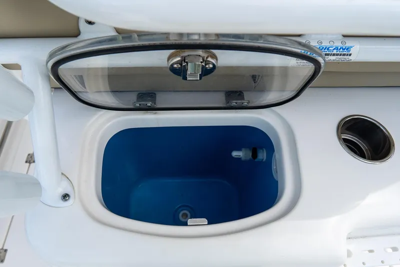 Slide: The Image of 2020 Tidewater 272 CC Adventure boat livewell with open lid and cup holder. - 29