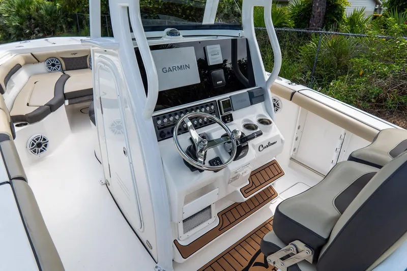 Slide: The Image of 2020 Tidewater 272 CC Adventure boat interior with Garmin navigation system and seating. - 30