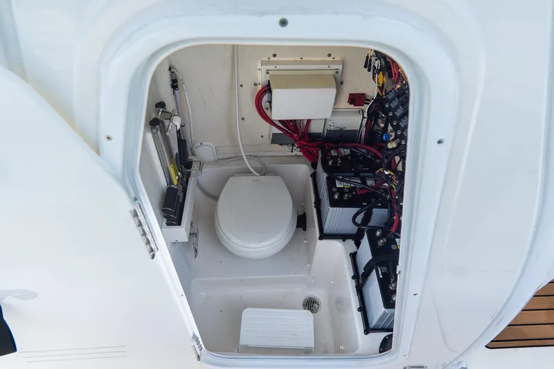 Slide: The Image of 2020 Tidewater 272 CC Adventure boat interior with toilet and electrical components. - 39
