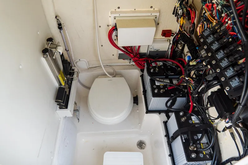 Slide: The Image of 2020 Tidewater 272 CC Adventure boat interior with wiring and marine toilet. - 40