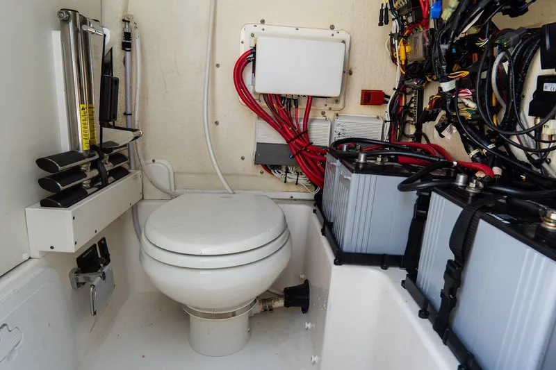 Slide: The Image of 2020 Tidewater 272 CC Adventure boat interior with toilet and electrical wiring. - 41