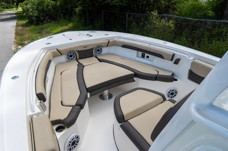 Slide: The Image of 2020 Tidewater 272 CC Adventure boat interior with cushioned seating and speakers. - 42