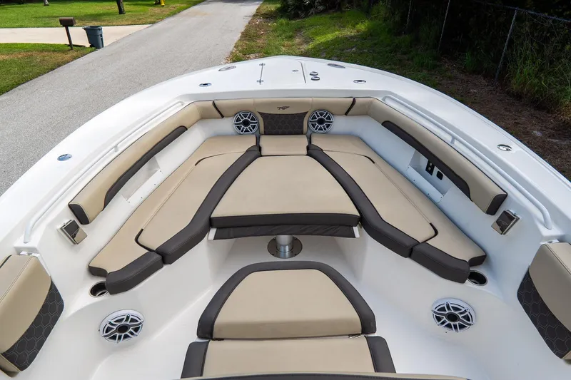 Slide: The Image of 2020 Tidewater 272 CC Adventure boat interior with cushioned seating and speakers. - 43
