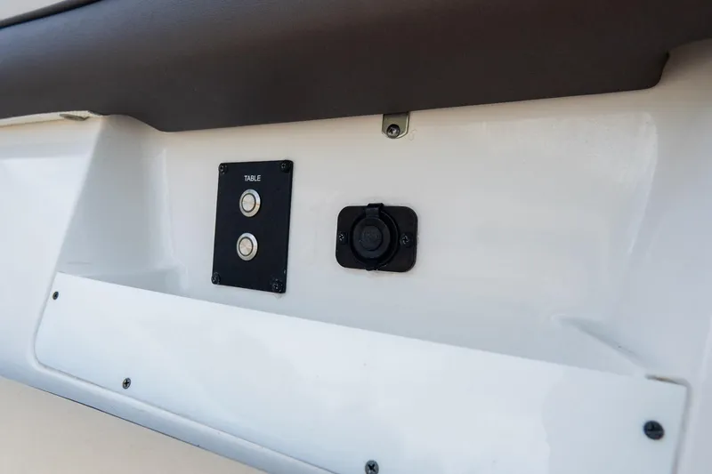 Slide: The Image of Control panel on 2020 Tidewater 272 CC Adventure boat, featuring table buttons and socket. - 49