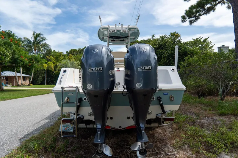 Slide: The Image of 2020 Tidewater 272 CC Adventure boat with dual Yamaha 200 engines, parked outdoors. - 5