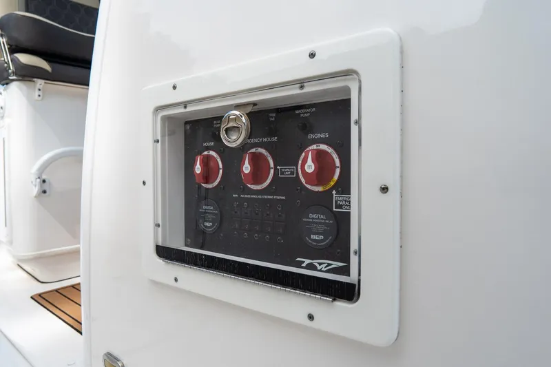 Slide: The Image of Control panel on a 2020 Tidewater 272 CC Adventure boat, featuring red switches. - 52