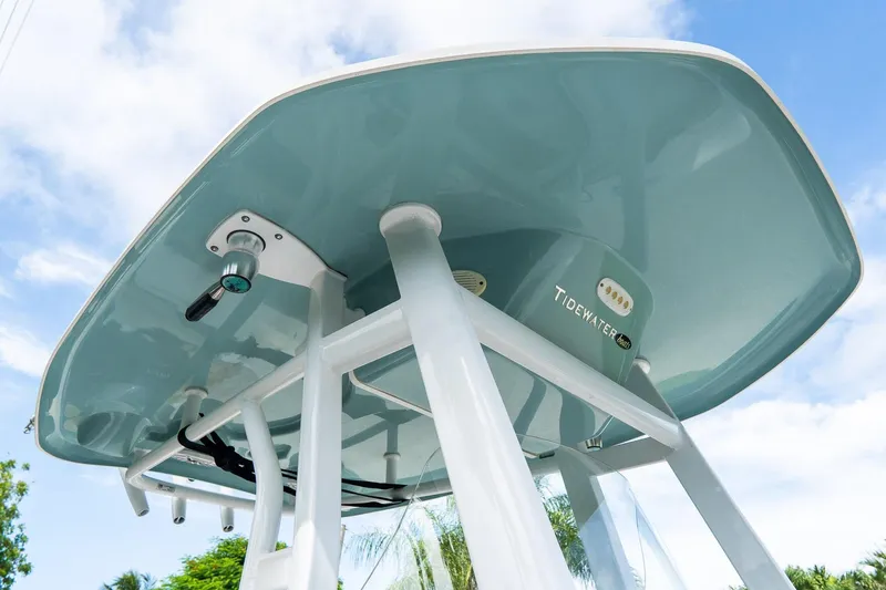 Slide: The Image of 2020 Tidewater 272 CC Adventure boat, underside view with blue sky background. - 53