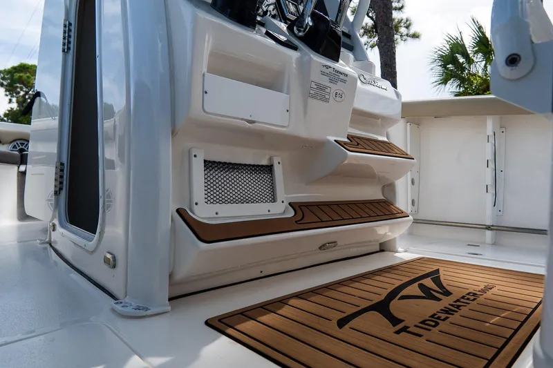 Slide: The Image of 2020 Tidewater 272 CC Adventure boat interior with teak accents and branded mat. - 54