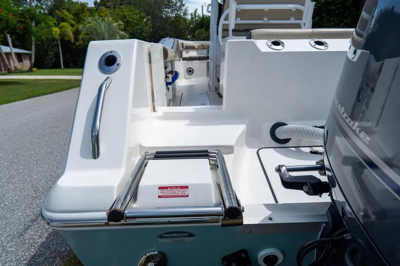 Slide: The Image of 2020 Tidewater 272 CC Adventure boat stern with ladder and engine details. - 8