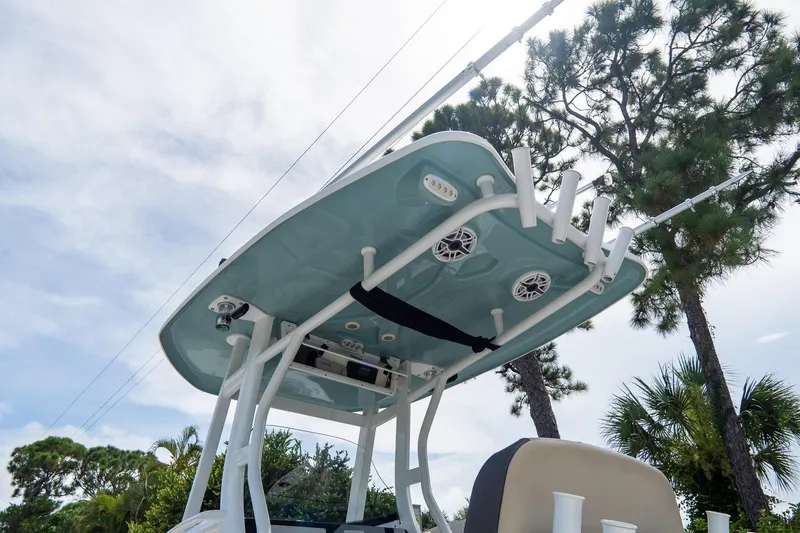 Slide: The Image of 2020 Tidewater 272 CC Adventure boat with T-top and rod holders against a sky backdrop. - 9