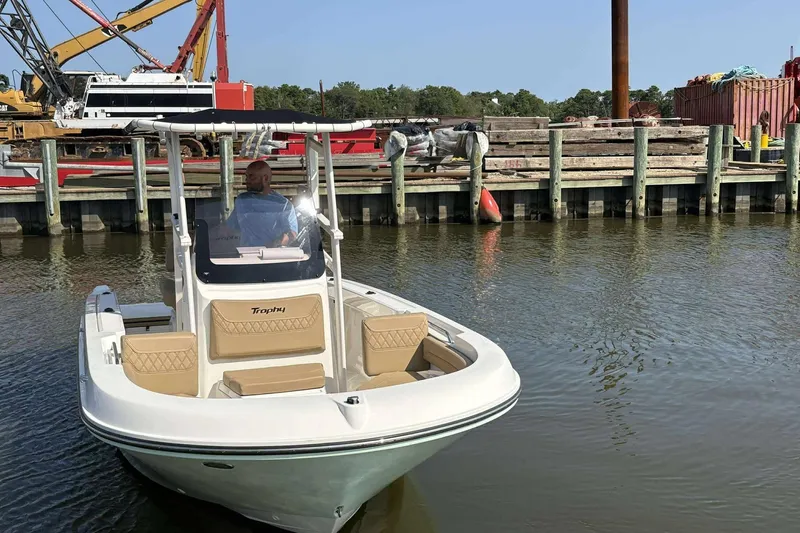 Slide: The Image of 2022 Bayliner Trophy T20CC boat docked near industrial waterfront. - 11