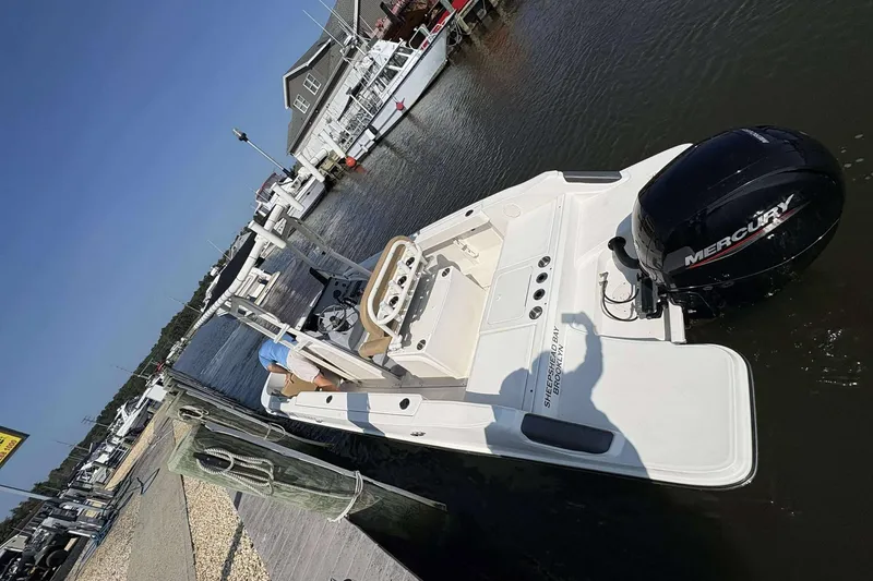 Slide: The Image of 2022 Bayliner Trophy T20CC boat docked with Mercury engine, sunny day. - 12
